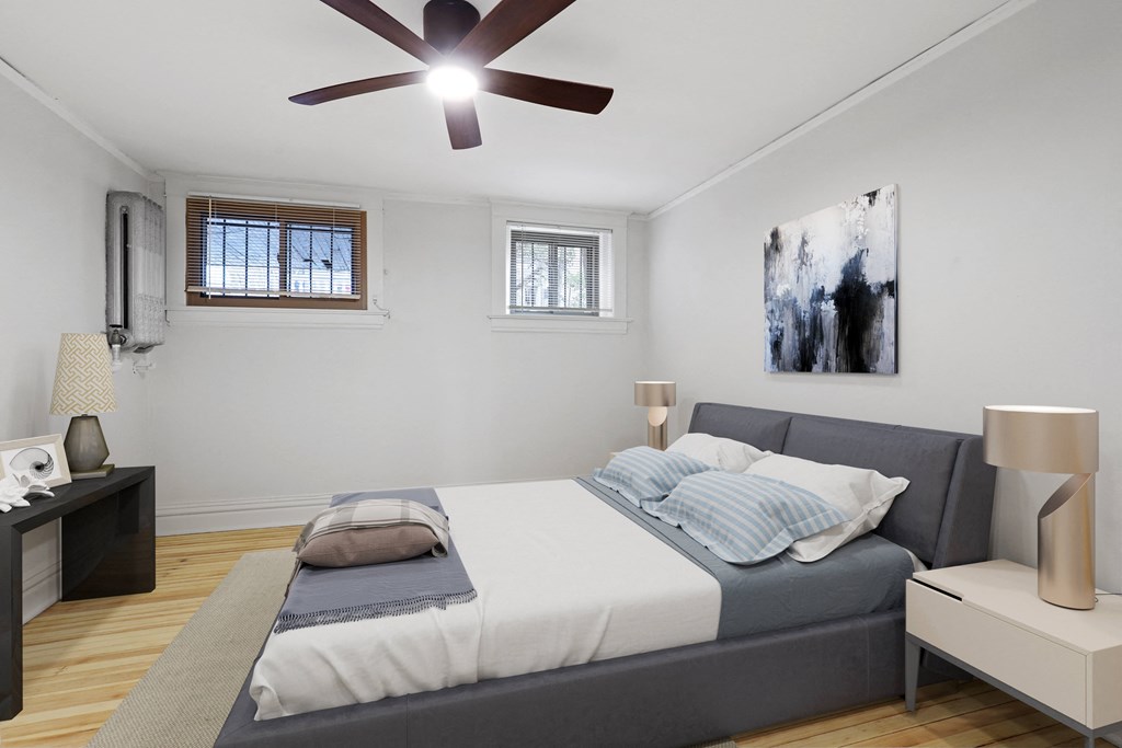 a bedroom with a large bed and a ceiling fan
