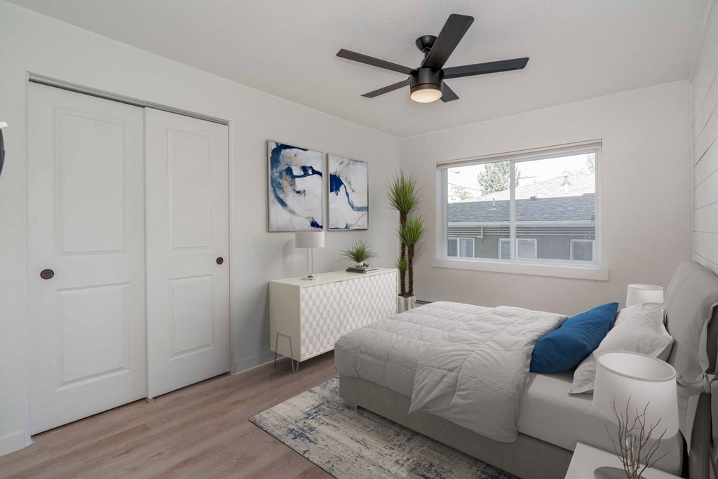 an open bedroom with a bed and a ceiling fan