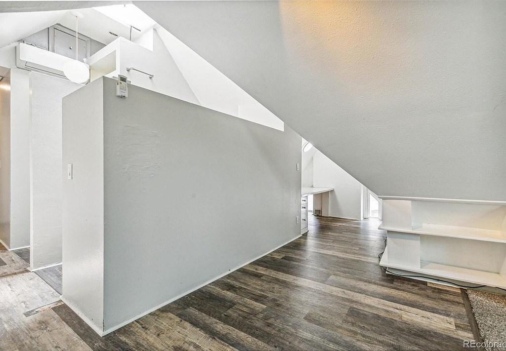 A room with wooden floors and white walls.