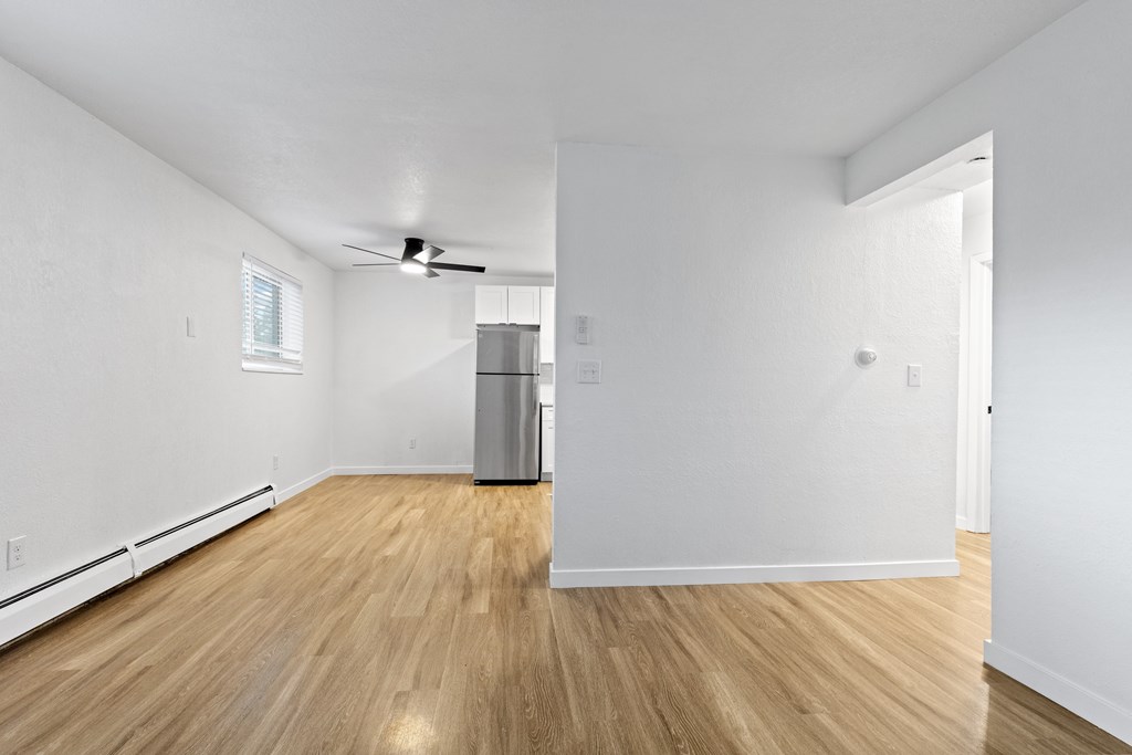 A room with a wooden floor and white walls.