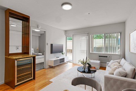 A modern living room with a grey couch and a wooden cabinet.