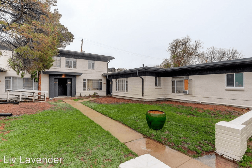 a white house with a yard and a sidewalk