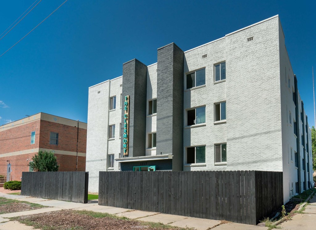 a white building with a fence in front of it