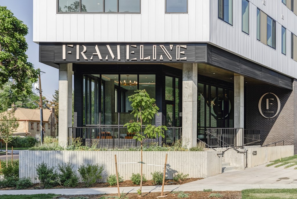 The building has a black and white facade with the word "FRAMELINE" on the top.