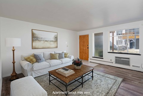 a living room with a white couch and a coffee table