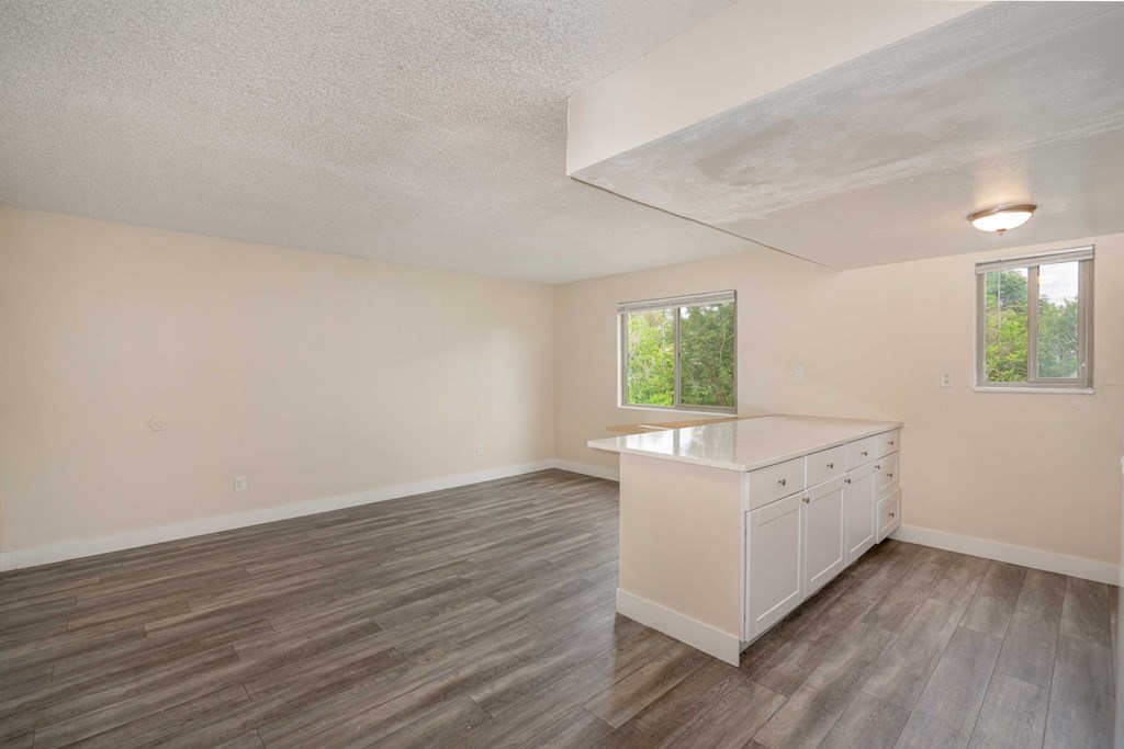 a rendering of a room with a row of white cabinets and a ceiling with a