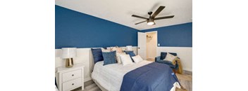 bedroom with a bed and a ceiling fan at The Iris Apartments, Colorado