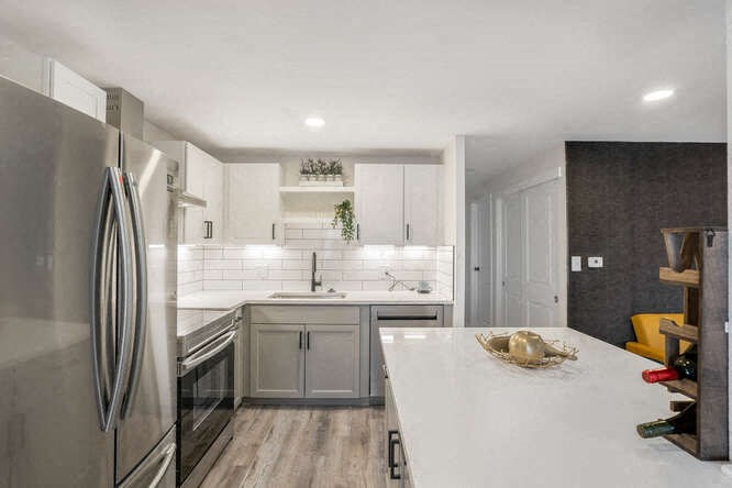 a kitchen with a white counter top and a refrigerator at The Iris Apartments, Colorado,80002