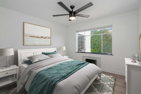A bedroom with a bed, nightstand, and a painting on the wall.