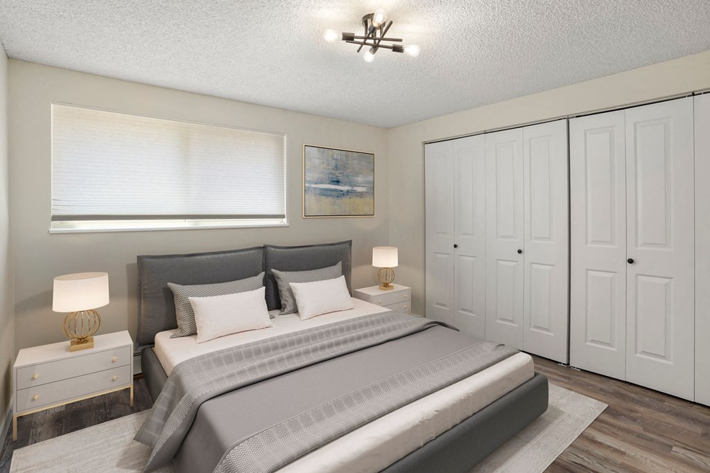 a bedroom with a bed and a window at The Iris Apartments, Arvada