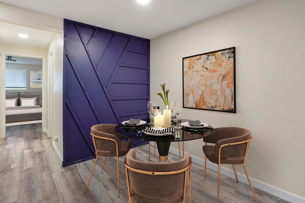 a dining room with a table and chairs and a purple door at The Iris Apartments, Colorado