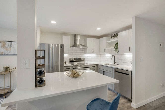 a kitchen with a white counter at The Iris Apartments, Colorado,80002