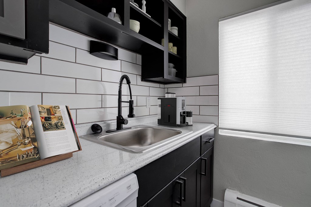 a kitchen with a sink and a window