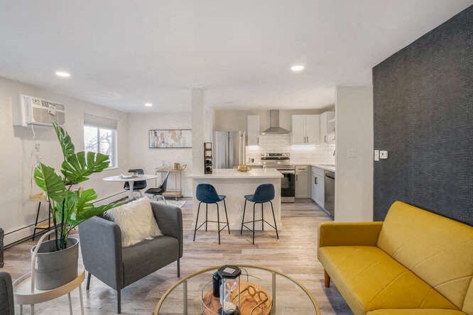 a room with a bunch of chairs and couches at The Iris Apartments, Arvada