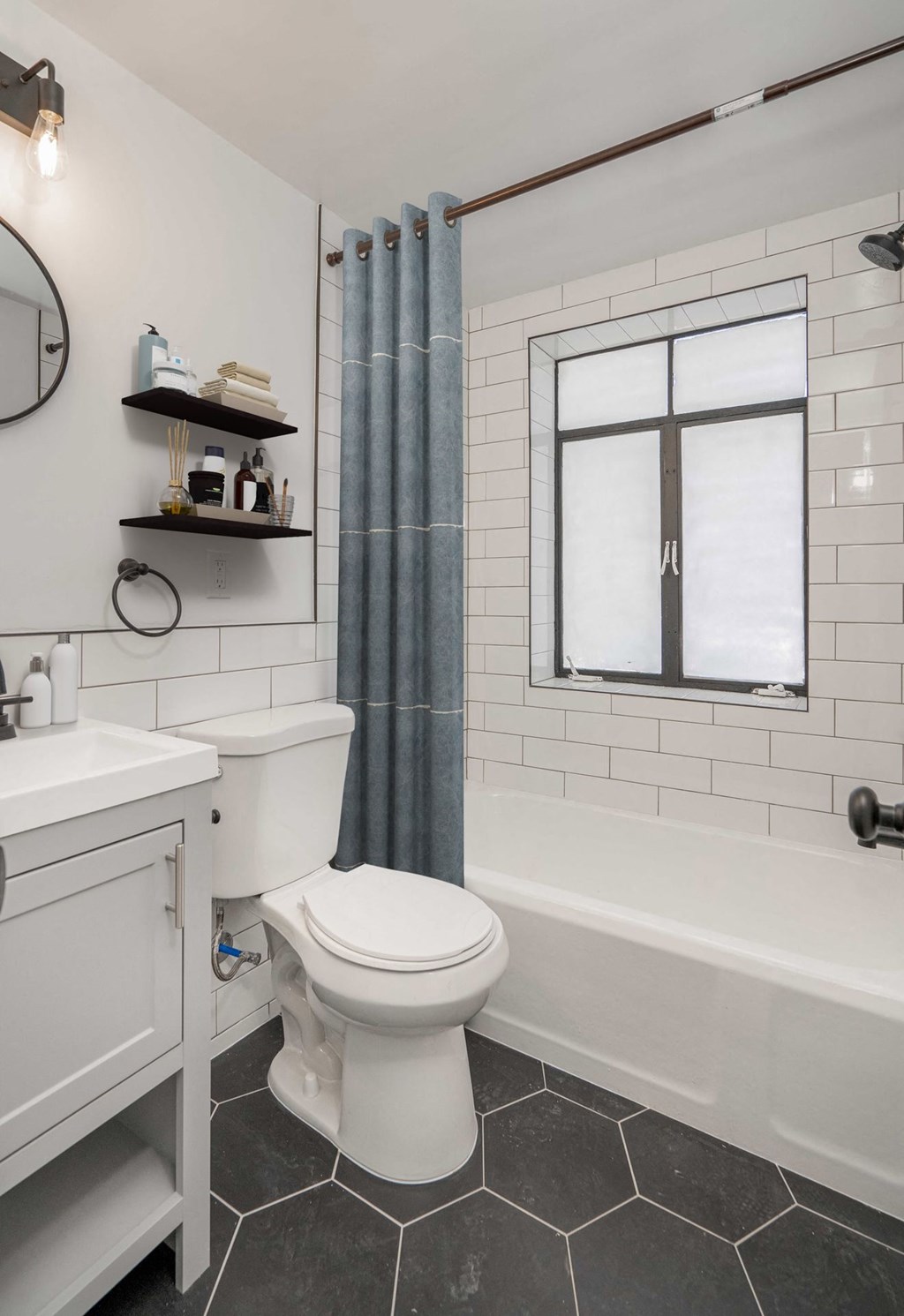 a bathroom with a toilet and a tub and a shower curtain