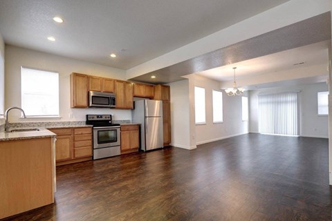 A kitchen with wooden cabinets and a refrigerator.