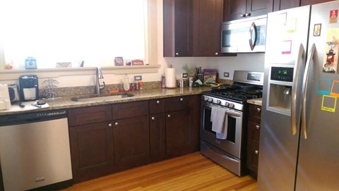 A kitchen with a stainless steel refrigerator and oven.