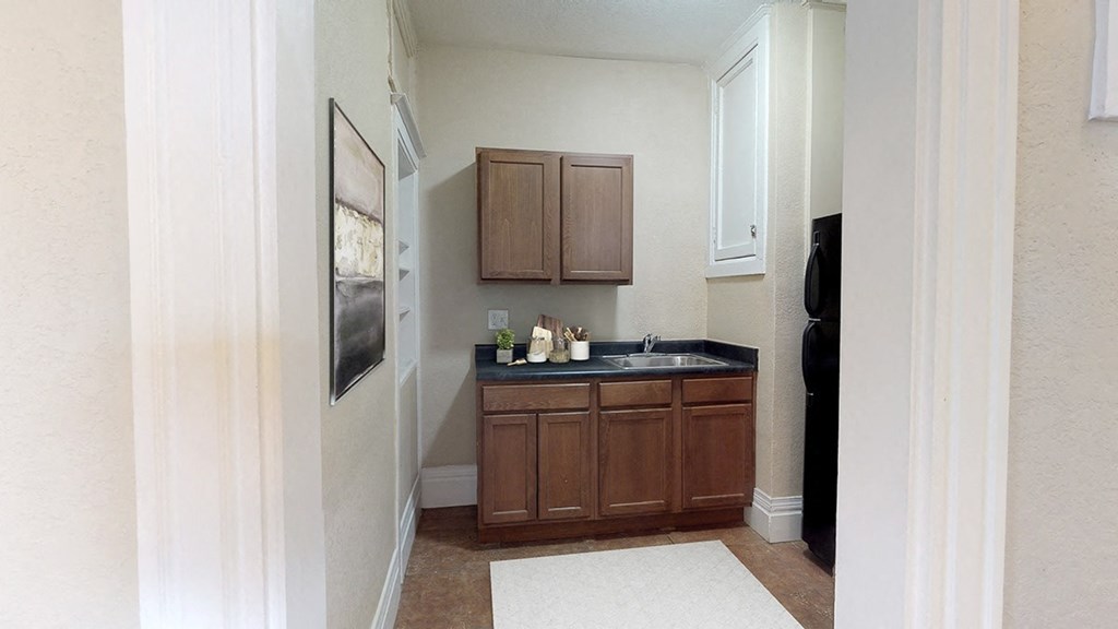 a bathroom with a sink and wooden cabinets