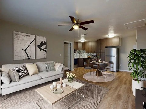 A living room with a couch, coffee table, and a ceiling fan.