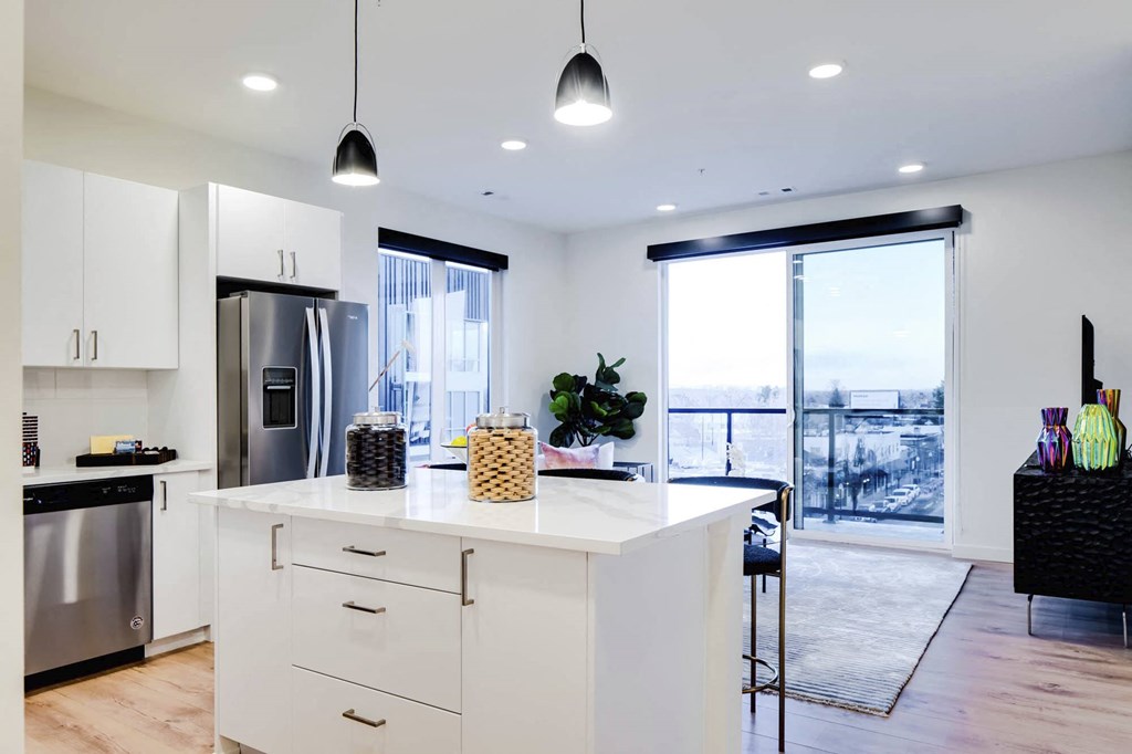 a kitchen with a large center island next to a doorway