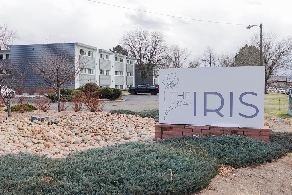 the sign in front of the apartments at The Iris Apartments, Arvada, Colorado