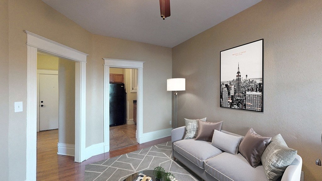 a living room with a couch and a lamp