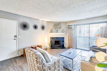 A living room with a fireplace and a chair.