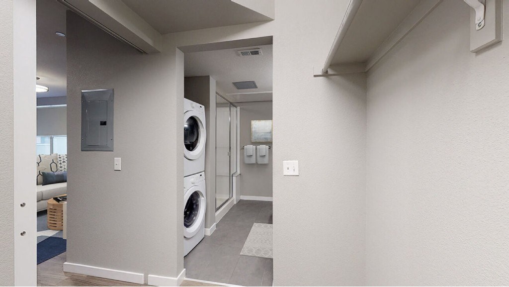 A laundry room with a washer and dryer.at The Logan Apartments, Colorado