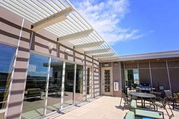 A sunny day at the outdoor seating area of a modern building.