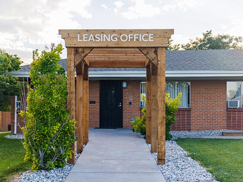 A leasing office is surrounded by a small garden.