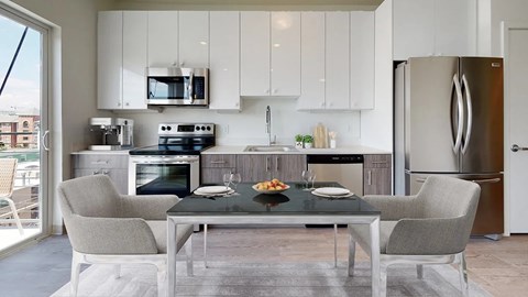 A modern kitchen with a glass table and chairs.