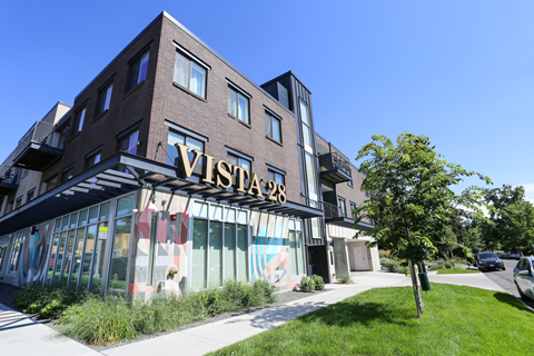 the facade of a building with a sign that reads vision bar