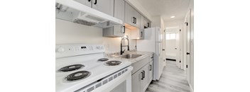 a white kitchen with white appliances and white cabinets