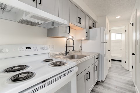 a white kitchen with white appliances and white cabinets