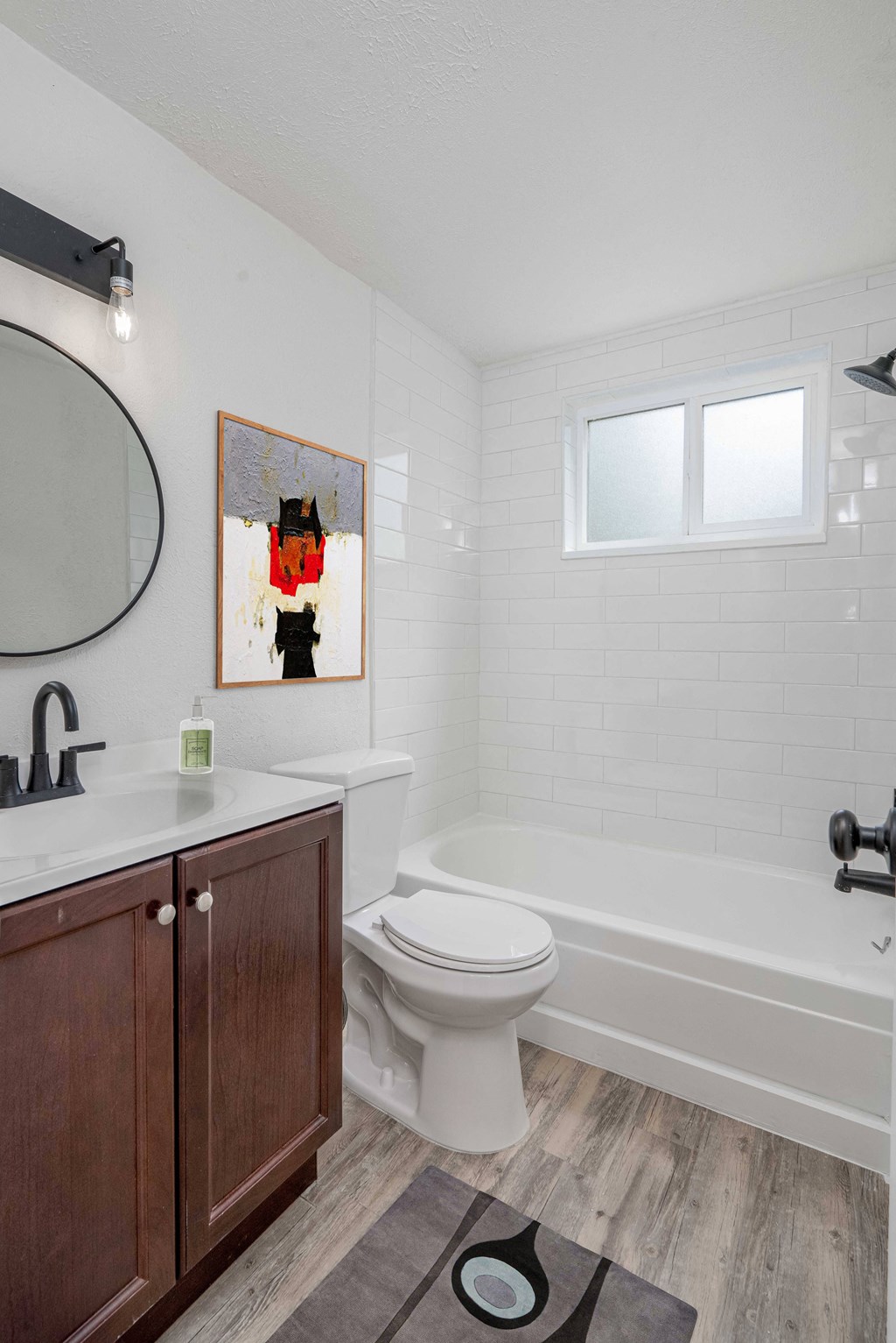 a bathroom with a toilet and a tub and a sink