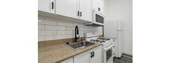 a kitchen with white appliances and a sink