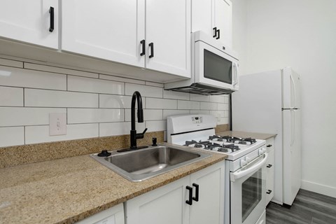 a kitchen with white appliances and a sink