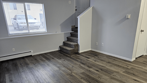 A room with a staircase leading to a second floor.