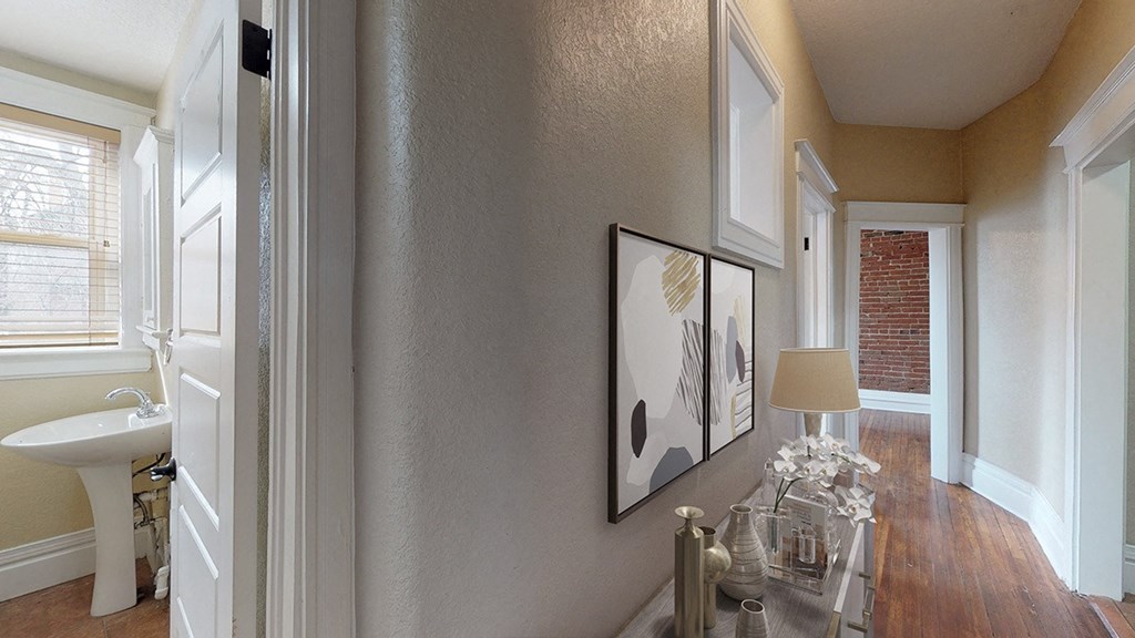 a living room with a table and a picture on the wall