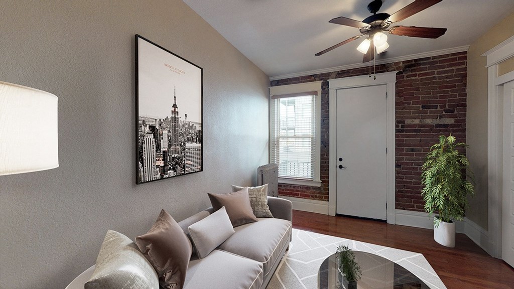 a living room with a couch and a ceiling fan