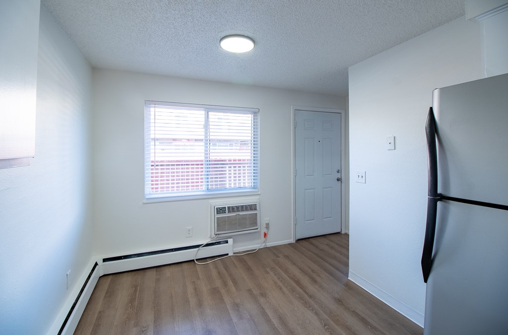 A room with a window and a white door.
