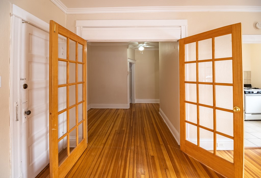 A room with a wooden floor and a white door.