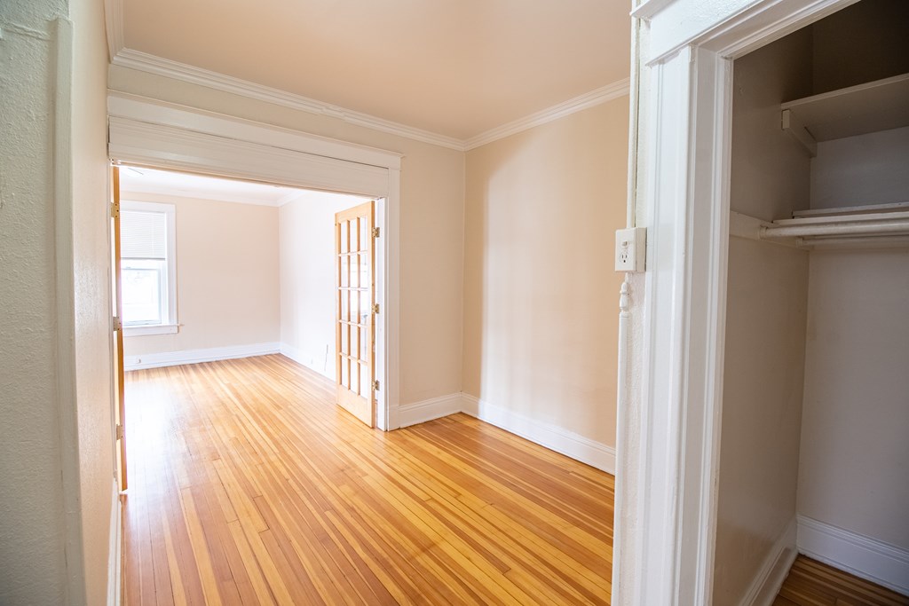 A room with wooden floors and white walls.