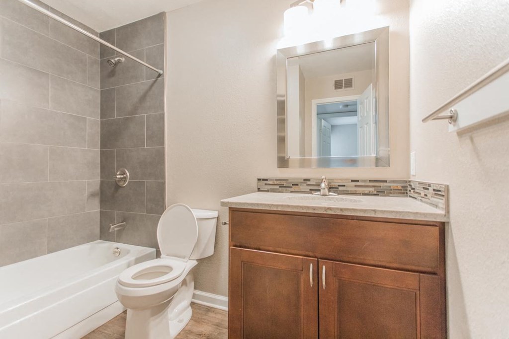 a bathroom with a toilet and a sink and a shower