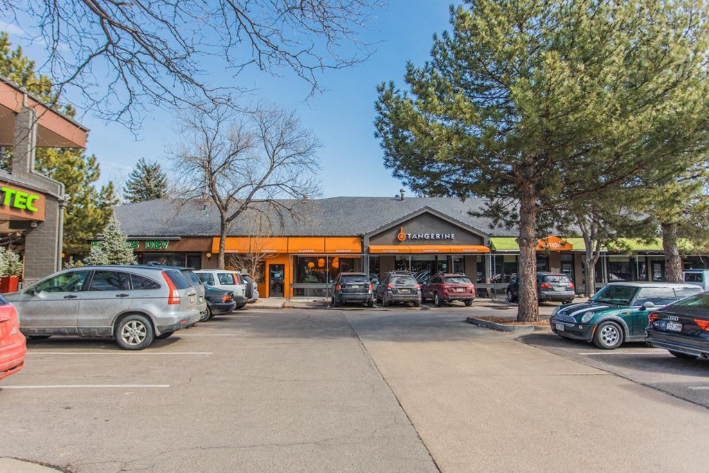 a parking lot in front of a building with cars parked