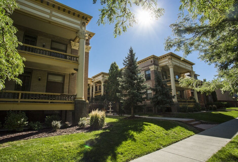 a sidewalk in front of houses on a sunny day
