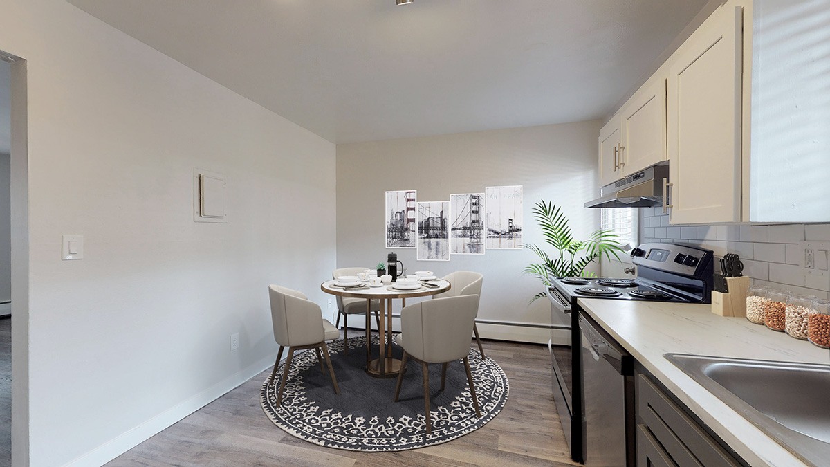A kitchen with a table and chairs in the middle of the room.