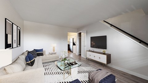 A modern living room with a glass coffee table and a white sofa.