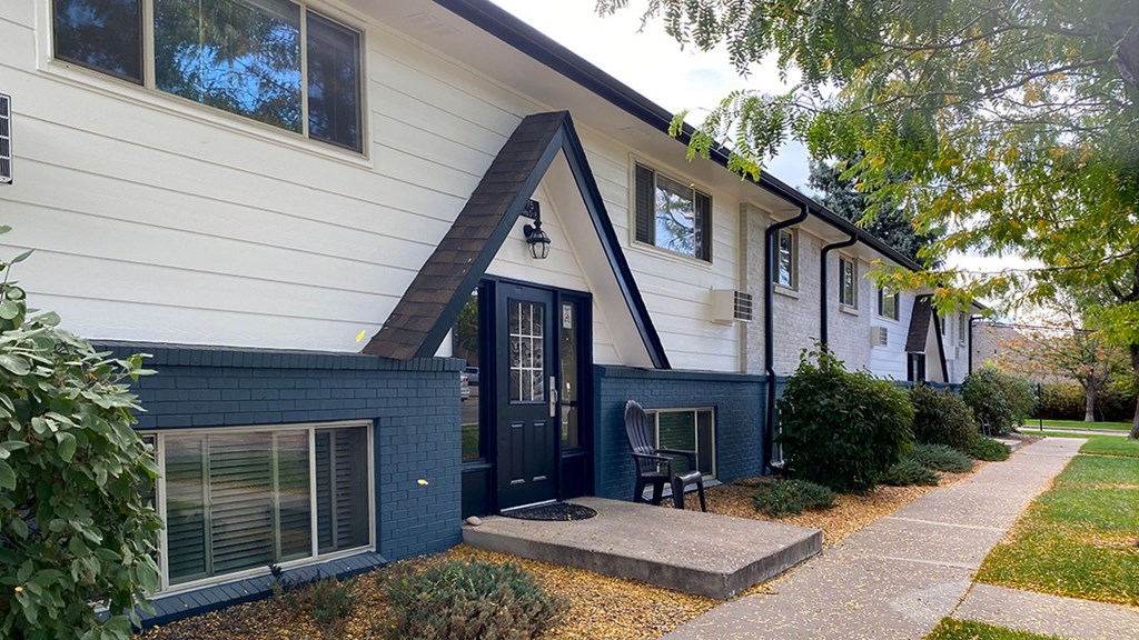 A white house with a black door and windows.