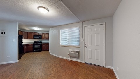 A room with wooden floors and a white door.